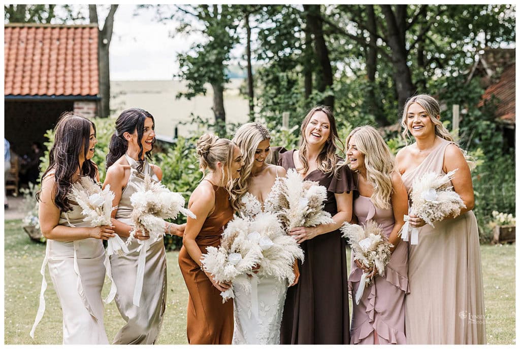 Natrual and relaxed wedding photography in Yorkshire. Bride and bridesmaids laughing together